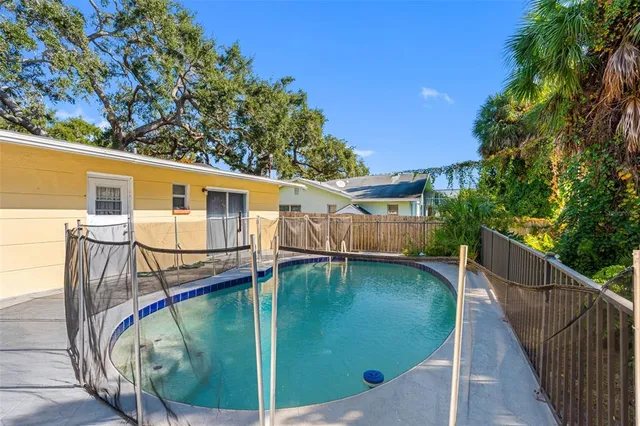 a view of a balcony with floor to ceiling windows and wooden fence
