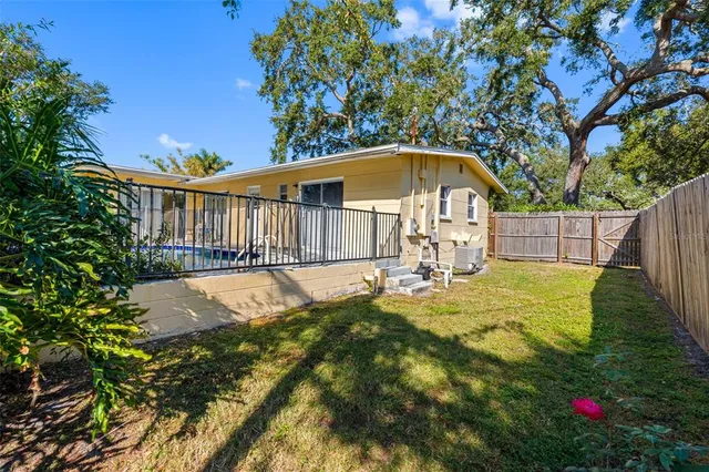 a view of swimming pool with a small yard
