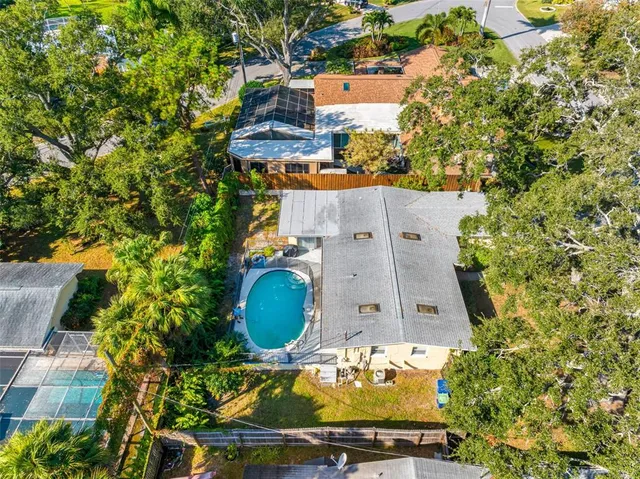 an aerial view of a house with yard swimming pool and outdoor seating