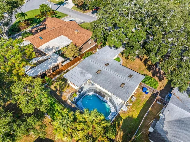 an aerial view of a house with a yard and swimming pool