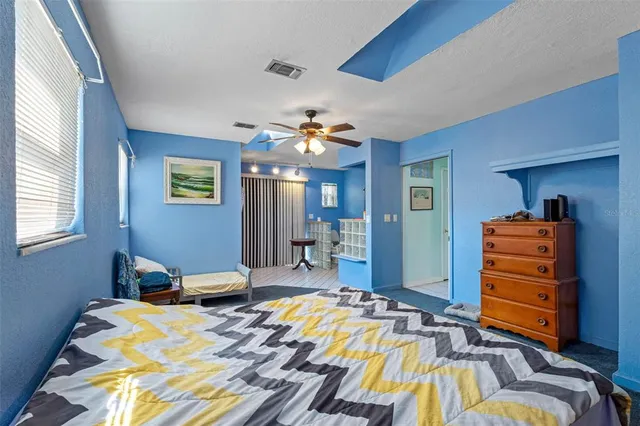 a bedroom with a bed and a chandelier