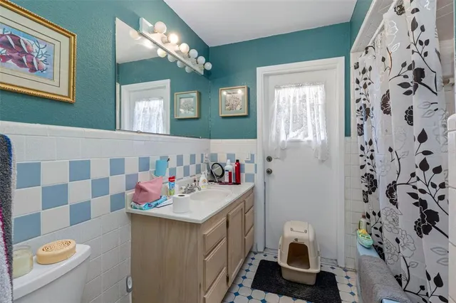 a bathroom with a sink mirror vanity and toilet