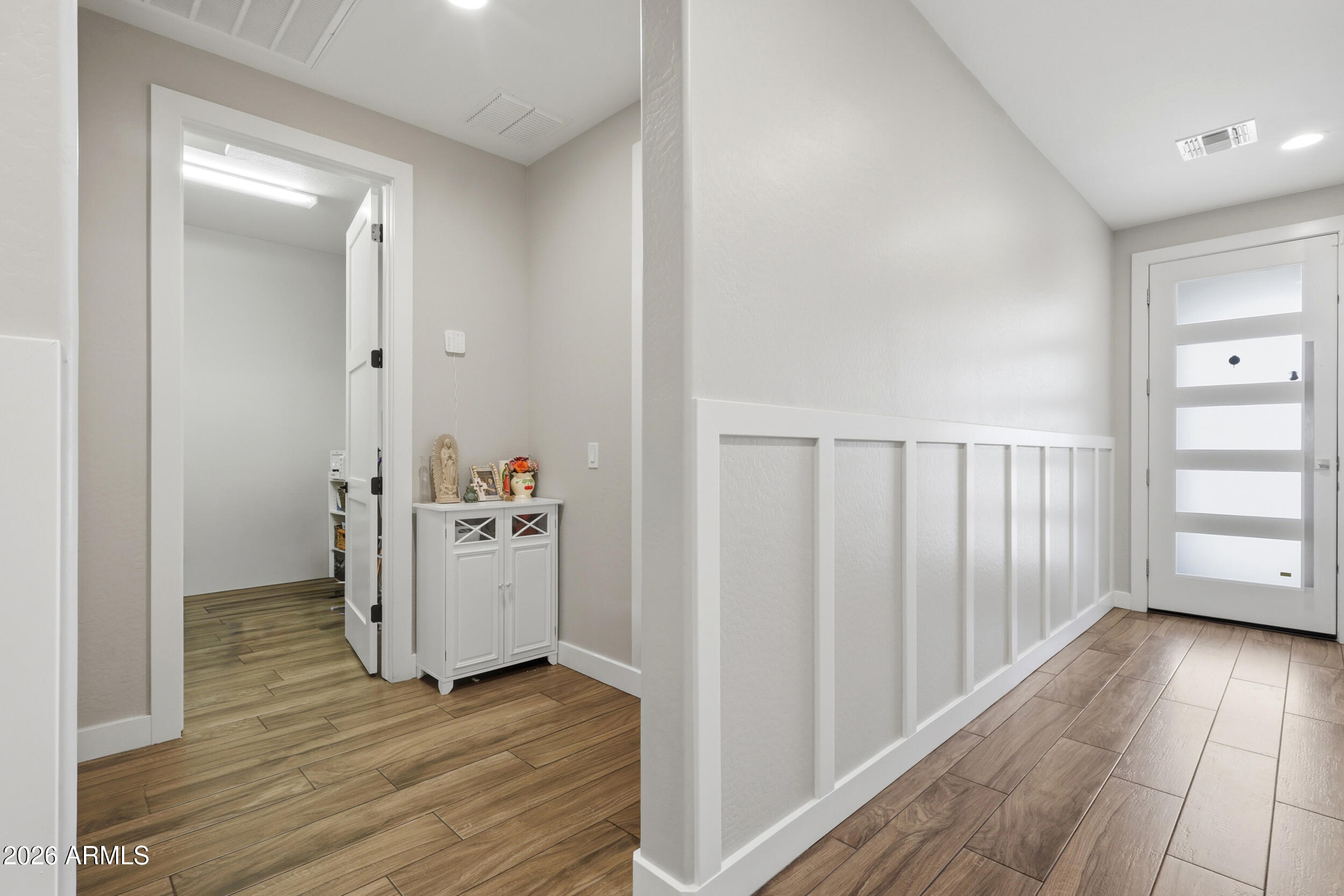 12517 West Lawrence Road Glendale, AZ 85307 - Photo 12 of 52 a view of a hallway with wooden floor and closet area