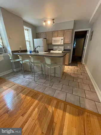 a kitchen with stainless steel appliances kitchen island granite countertop a sink and cabinets