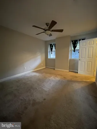 a view of a livingroom with a ceiling fan and window