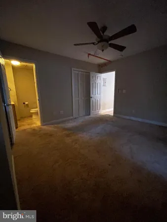 a view of a livingroom with a ceiling fan and window