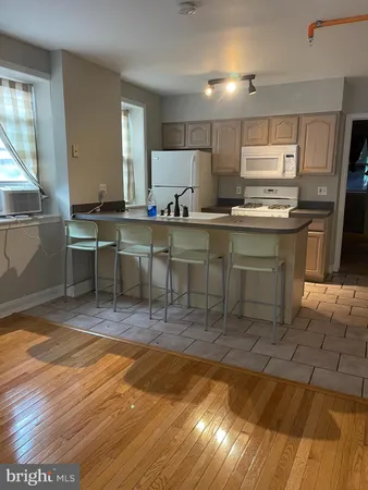 a view of kitchen with sink dining table and chairs