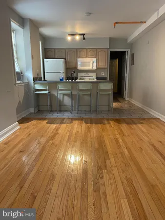 a kitchen with wooden floors and wooden cabinets