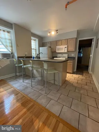 a kitchen with stainless steel appliances kitchen island granite countertop a sink and cabinets