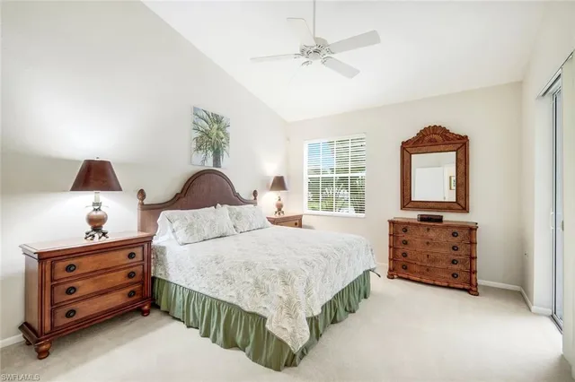 a bedroom with a bed a dresser and a window