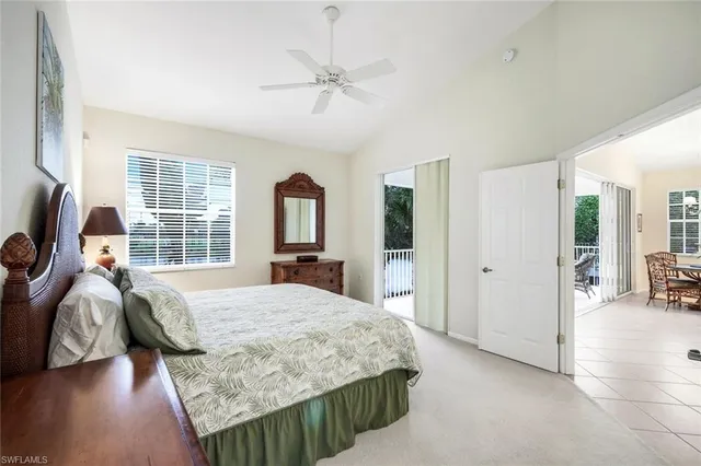 a bedroom with a bed closet and a flat tv screen