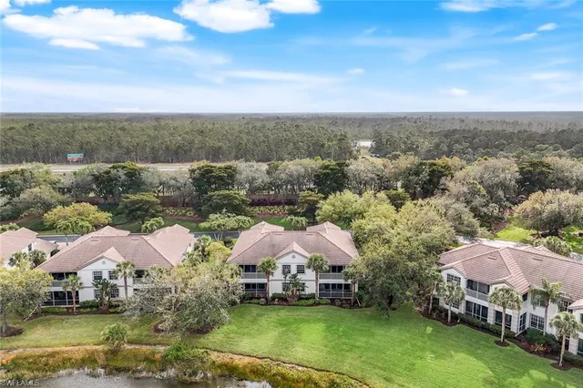 an aerial view of a house with swimming pool and mountains