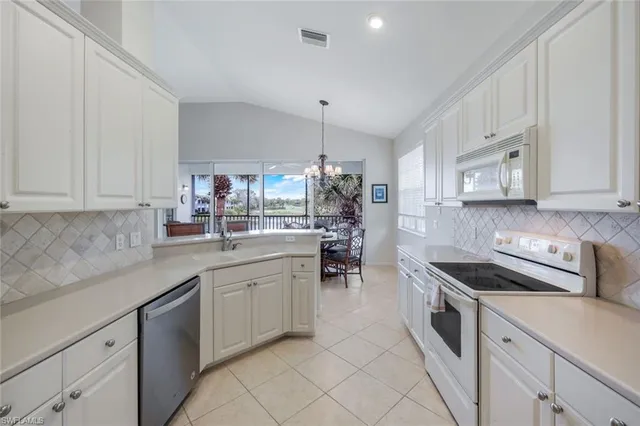 a kitchen with stainless steel appliances white cabinets and a sink