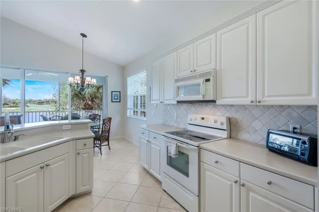a kitchen with appliances cabinets and a counter top space
