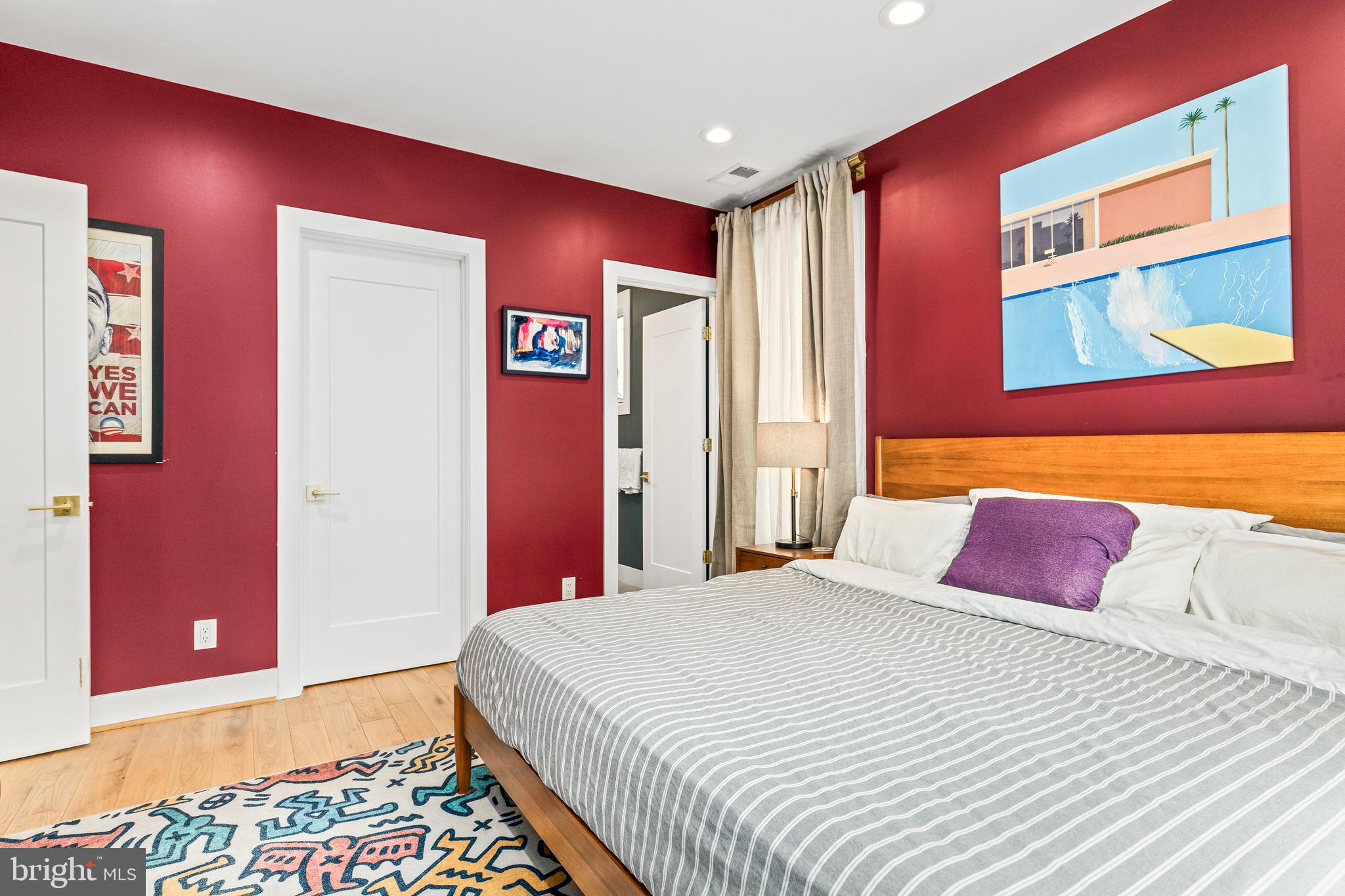 2234 11th Street Northwest, Unit 101 Washington, DC 20001 - Photo 13 of 25 a bedroom with a bed and a painting on the wall
