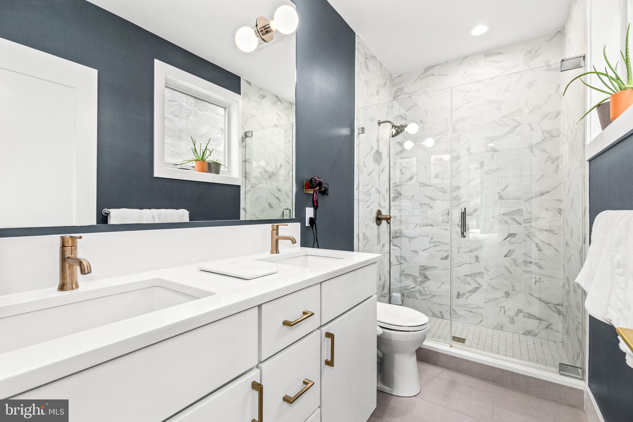 2234 11th Street Northwest, Unit 101 Washington, DC 20001 - Photo 14 of 25 a bathroom with a sink a toilet and shower