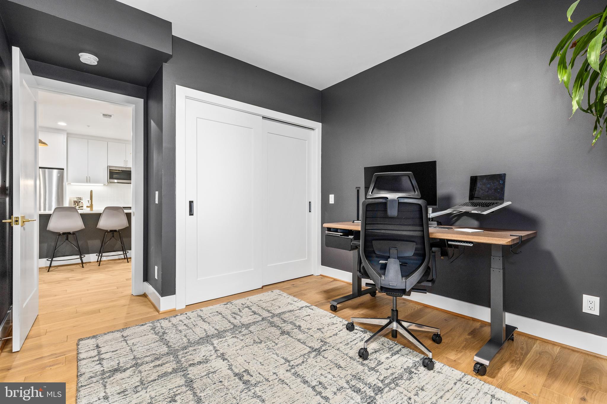 2234 11th Street Northwest, Unit 101 Washington, DC 20001 - Photo 17 of 25 a workspace with furniture and wooden floor