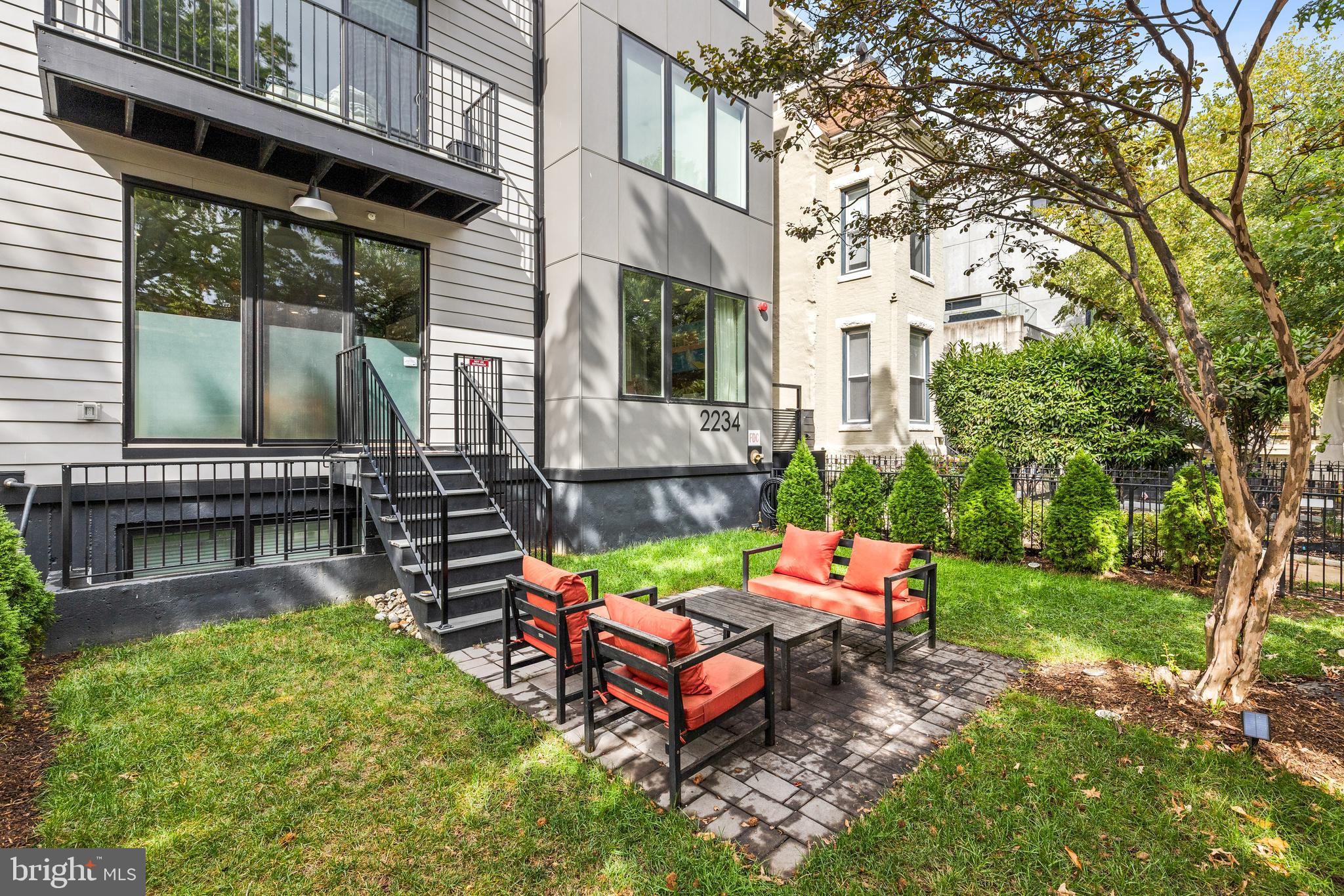 2234 11th Street Northwest, Unit 101 Washington, DC 20001 - Photo 22 of 25 a backyard of a house with table and chairs