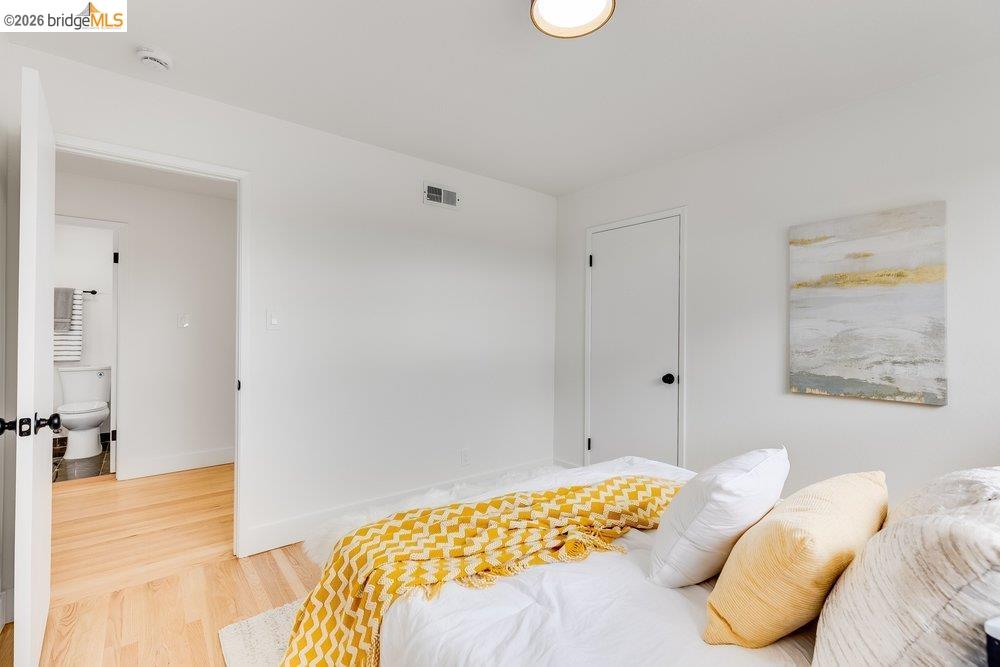 1298 Ribbon Street Foster City, CA 94404 - Photo 53 of 86 Room featuring light wood-finish flooring, white walls, and a contemporary flush-mount ceiling light