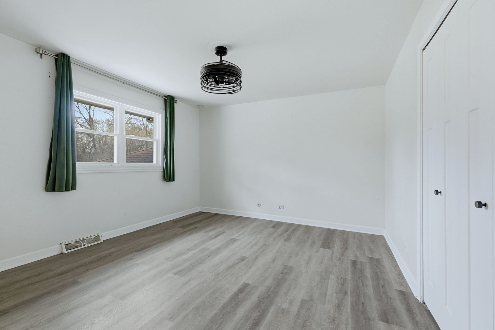 28-w032 Roosevelt Road Winfield, IL 60190 - Photo 12 of 35 a view of an empty room with a window and wooden floor