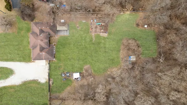 a aerial view of a house with a yard