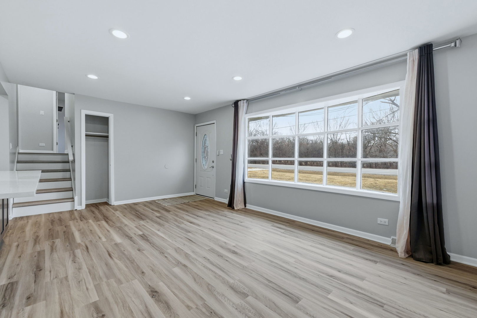 28-w032 Roosevelt Road Winfield, IL 60190 - Photo 5 of 35 a view of an empty room with wooden floor and a window