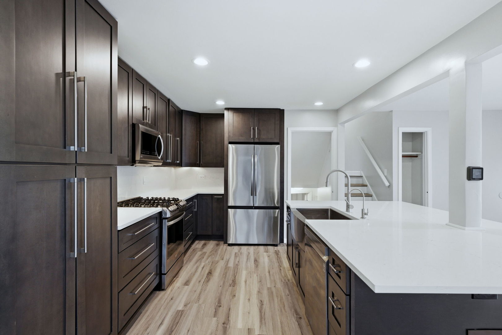 28-w032 Roosevelt Road Winfield, IL 60190 - Photo 6 of 35 a kitchen with stainless steel appliances granite countertop a refrigerator a stove and a sink with wooden floor