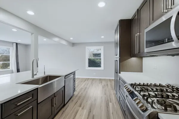 a kitchen with stainless steel appliances a sink stove and cabinets
