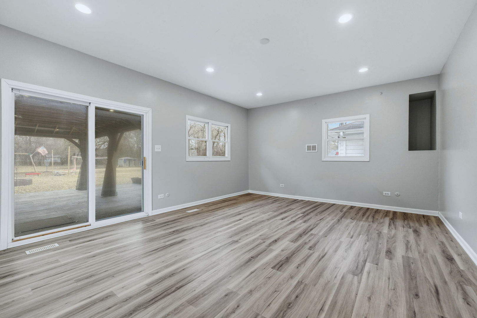 28-w032 Roosevelt Road Winfield, IL 60190 - Photo 9 of 35 a view of an empty room with wooden floor and a window
