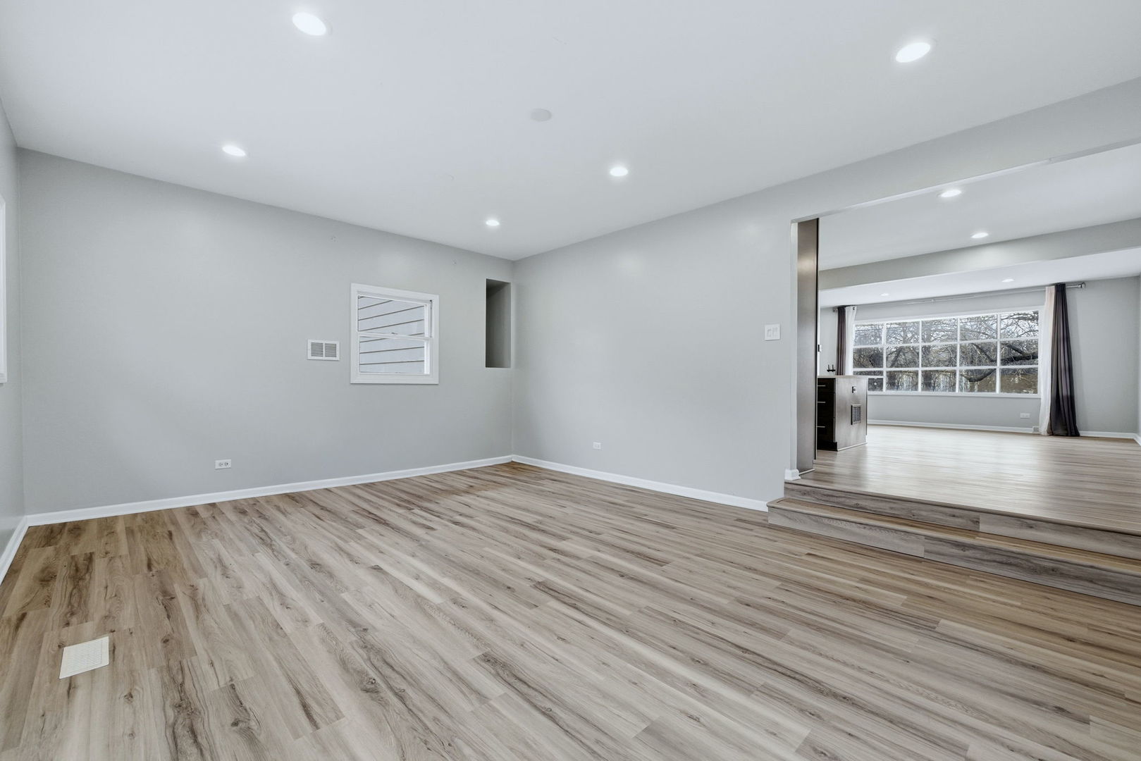28-w032 Roosevelt Road Winfield, IL 60190 - Photo 10 of 35 a view of an empty room with wooden floor and a window