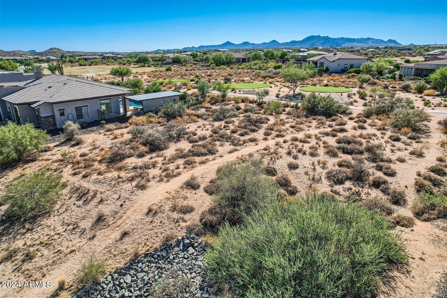 29406 North Round Butte Road, Unit 129 Rio Verde, AZ 85263 - Photo 4 of 32 an aerial view of residential houses with outdoor space and trees