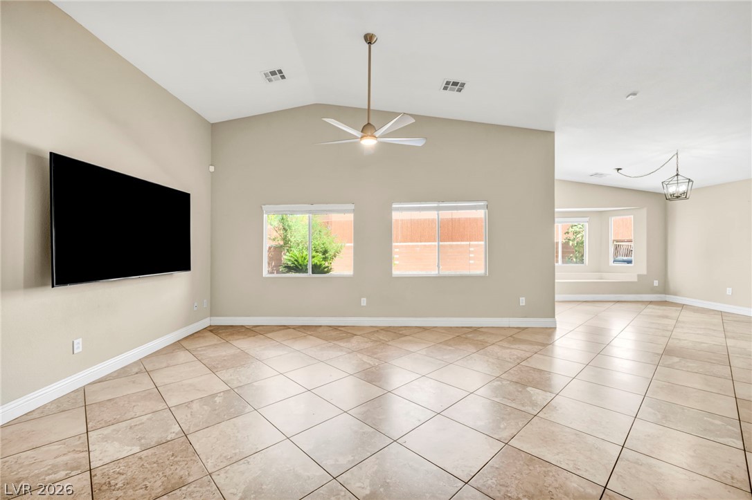 6405 North Raptor Court North Las Vegas, NV 89084 - Photo 13 of 66 A spacious living area featuring lofty vaulted ceilings and gleaming tile flooring.
