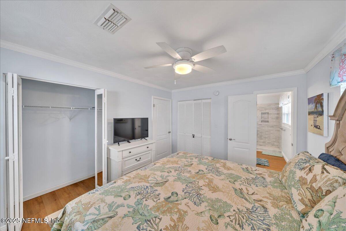 4491 Surfside Lane Port St. Joe, FL 32456 - Photo 22 of 84 a bedroom with a bed and a flat tv screen on dresser