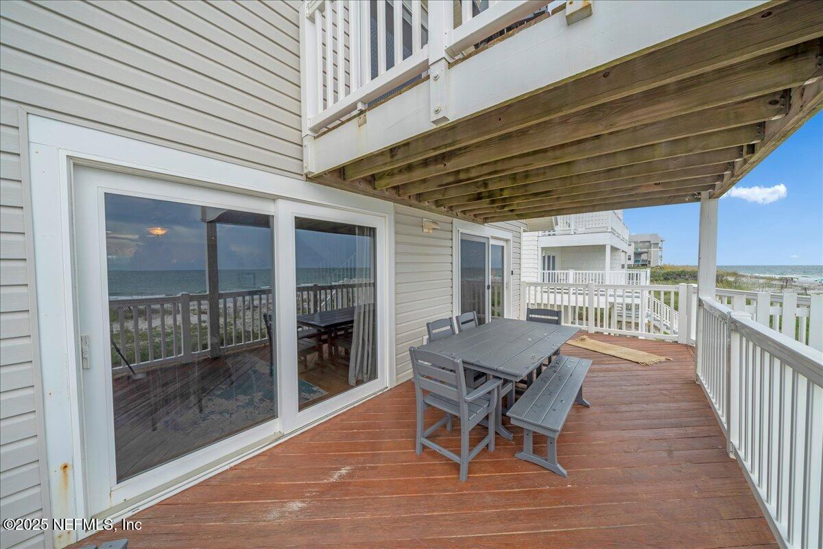 4491 Surfside Lane Port St. Joe, FL 32456 - Photo 40 of 84 a view of a roof deck with chair and wooden floor