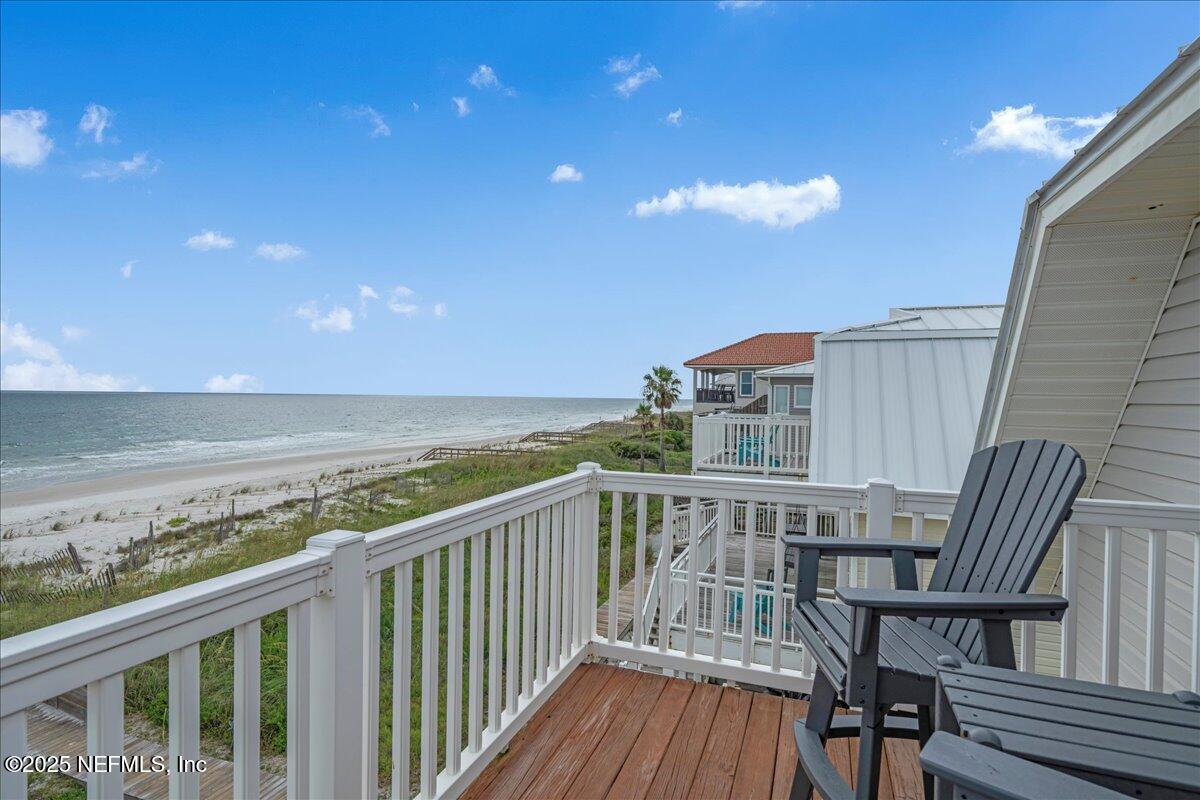 4491 Surfside Lane Port St. Joe, FL 32456 - Photo 43 of 84 a view of a balcony with wooden floor and iron fence