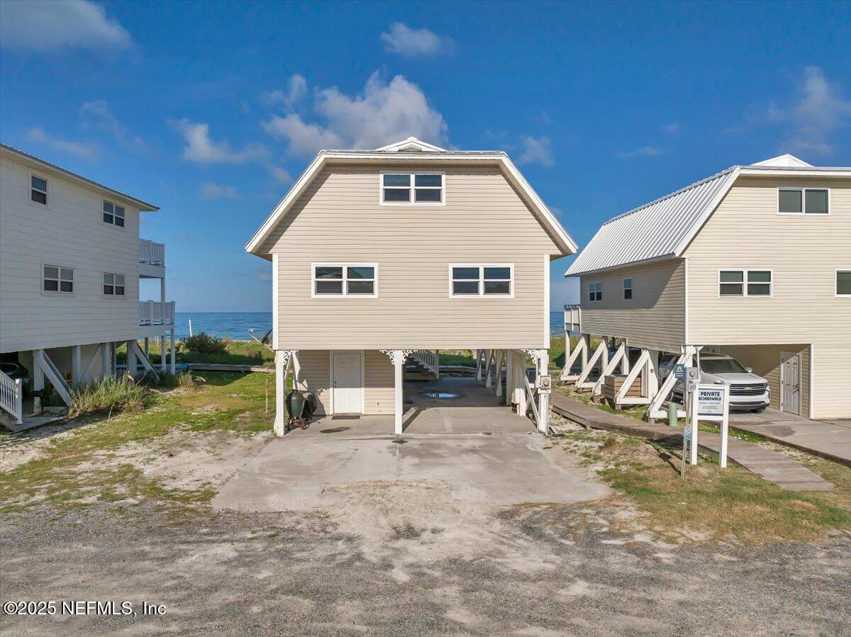 4491 Surfside Lane Port St. Joe, FL 32456 - Photo 59 of 84 a view of a house with backyard and chairs