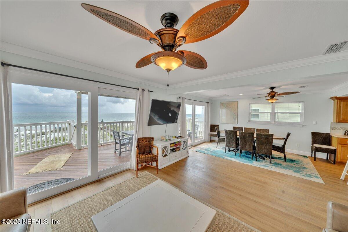 4491 Surfside Lane Port St. Joe, FL 32456 - Photo 8 of 84 a living room with furniture a flat screen tv and a large window