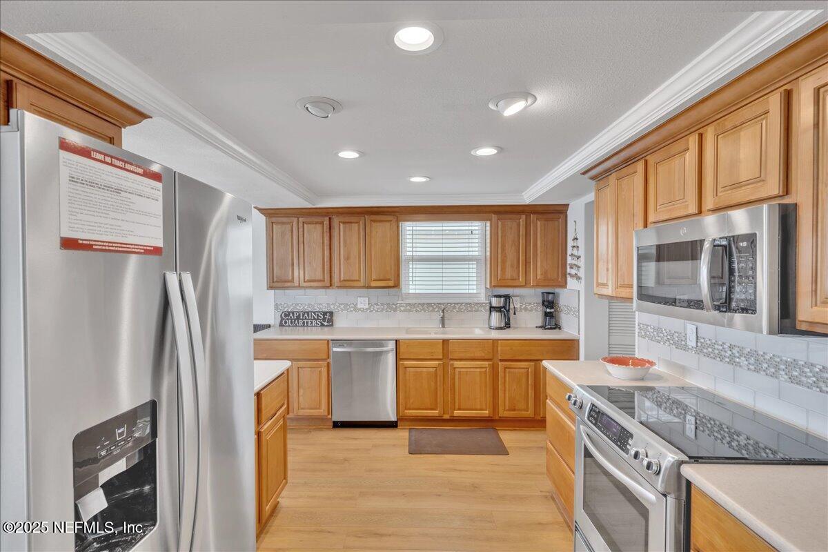 4491 Surfside Lane Port St. Joe, FL 32456 - Photo 9 of 84 a kitchen with a sink stove and refrigerator