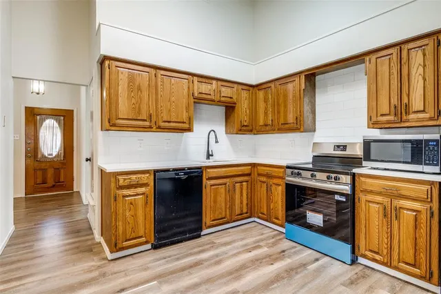 a kitchen with stainless steel appliances granite countertop a stove and a sink