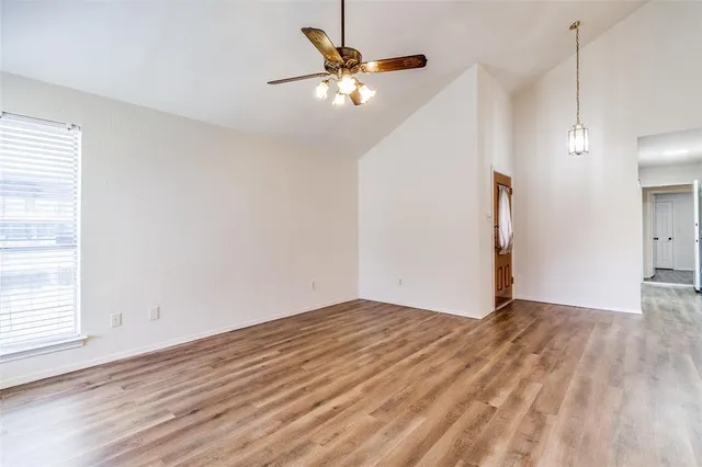 wooden floor in an empty room with a window