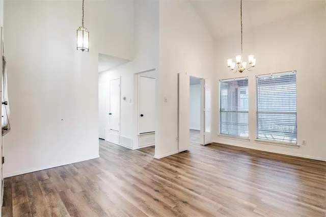 a view of a room with wooden floor and window