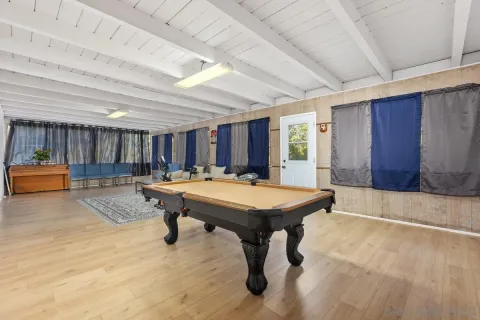 a room with furniture pool table and windows