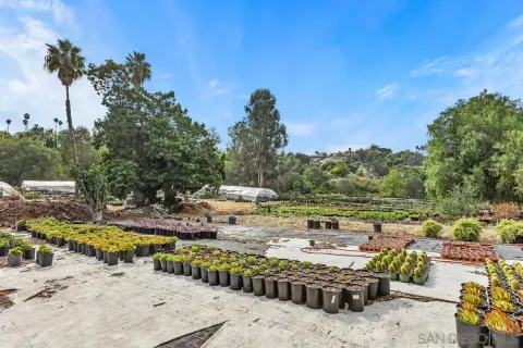 a view of a swimming pool with a patio and a yard