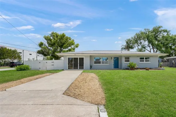 a front view of house with yard and green space