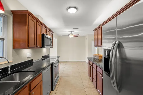 a kitchen with a sink cabinets and chandelier