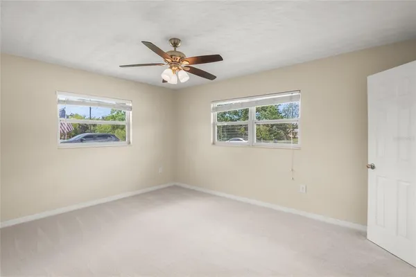 a bedroom with a bed and a potted plant