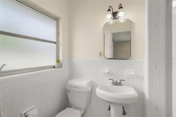 a bathroom with a toilet sink and shower
