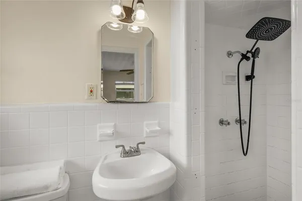 an empty room with a window and a ceiling fan