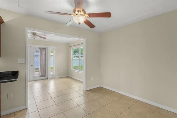 a view of an empty room with a kitchen