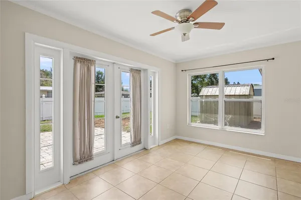 a view of an empty room with window and cabinet